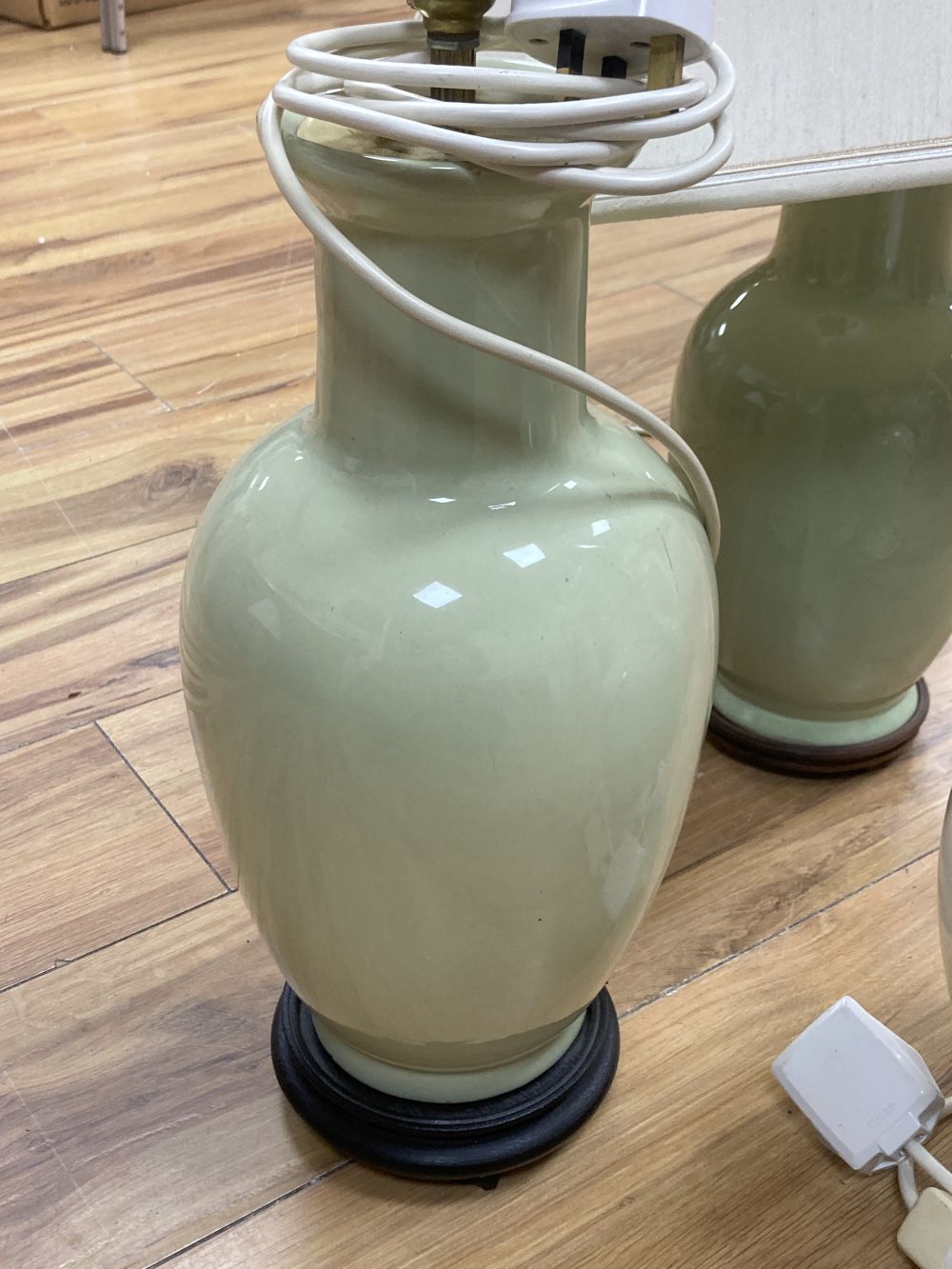 A pair lime-green glazed table lamps, 38cm, one with shade and one other earthenware lamp